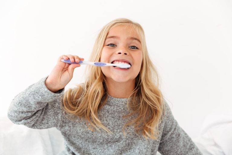 close-up-portrait-cute-kid-gray-pajamas-brushing-her-teeth-min-768x512